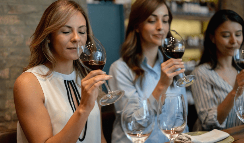 Group of women tasting wine.