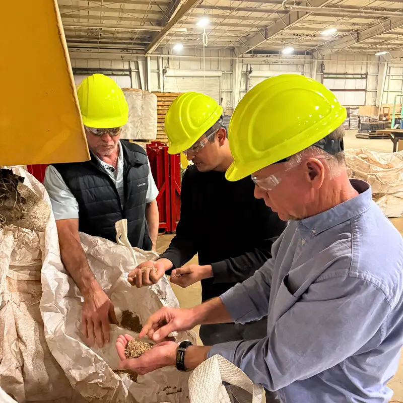 Owner showing off oak chips to employees